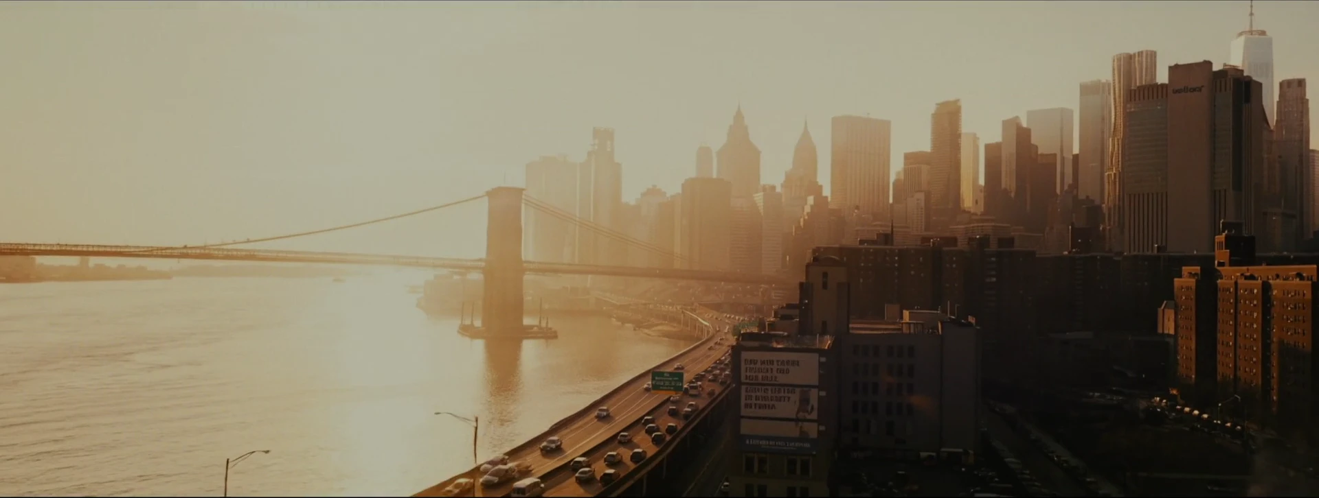 The river, bridge and city skyline stretch into warm sunset light.
