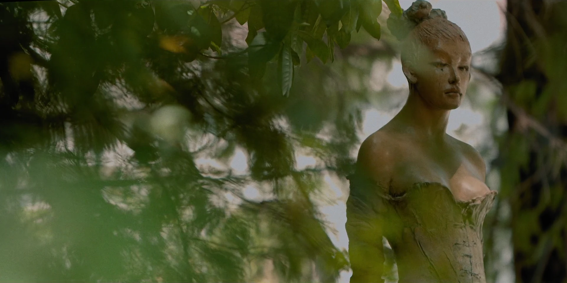 A sculpture among leaves