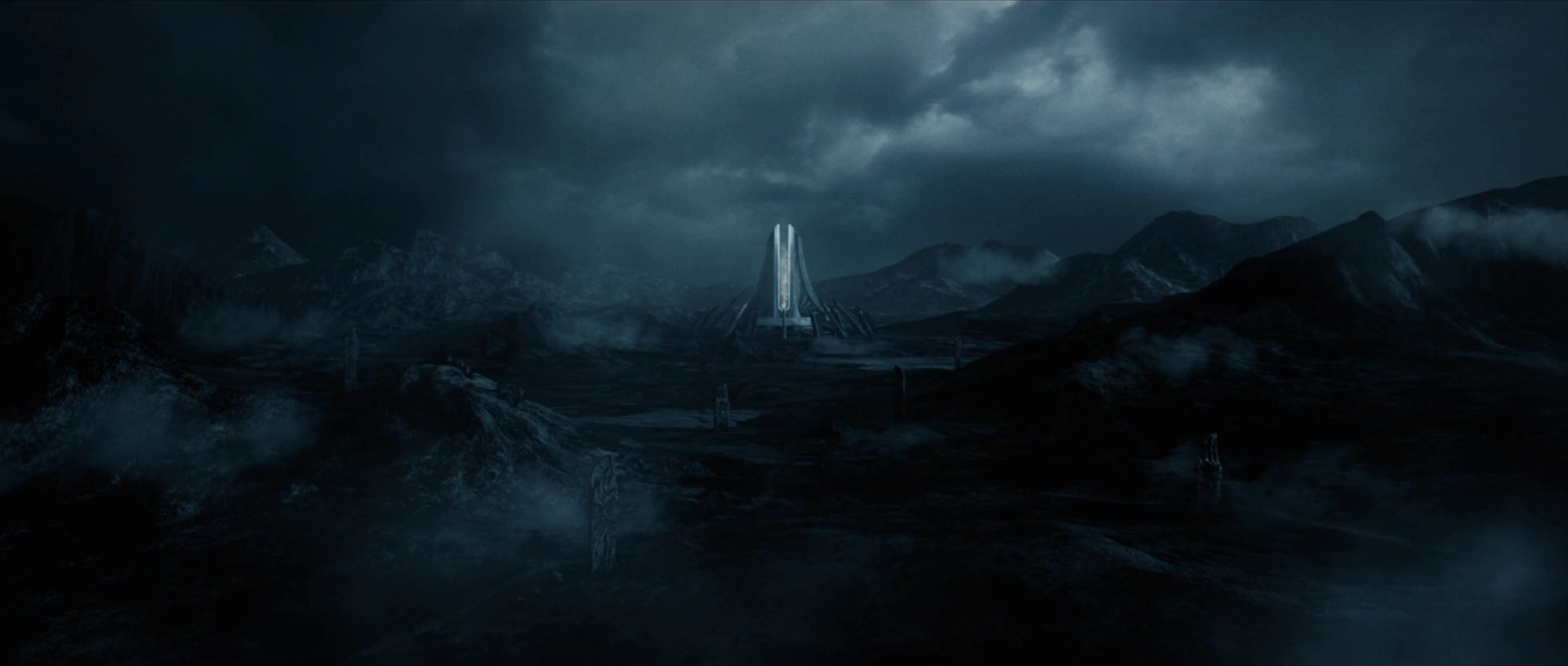 A distant tower rises beyond dark mountain ridges and storm clouds.