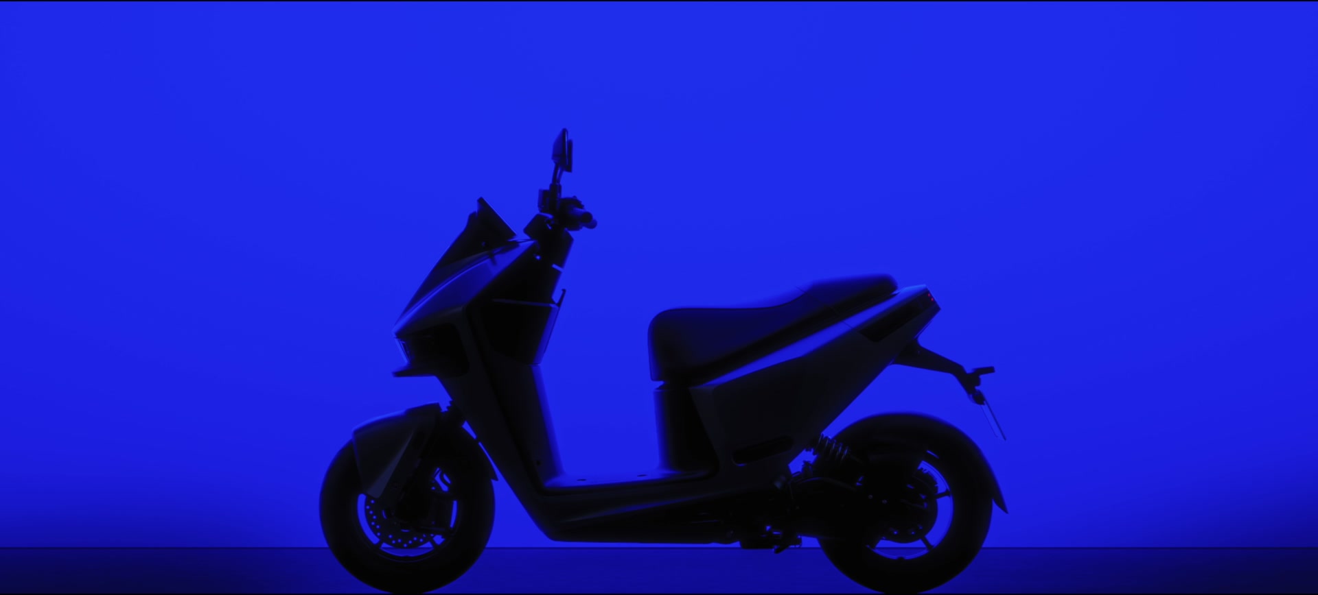 The complete PULSE scooter in profile against electric blue.