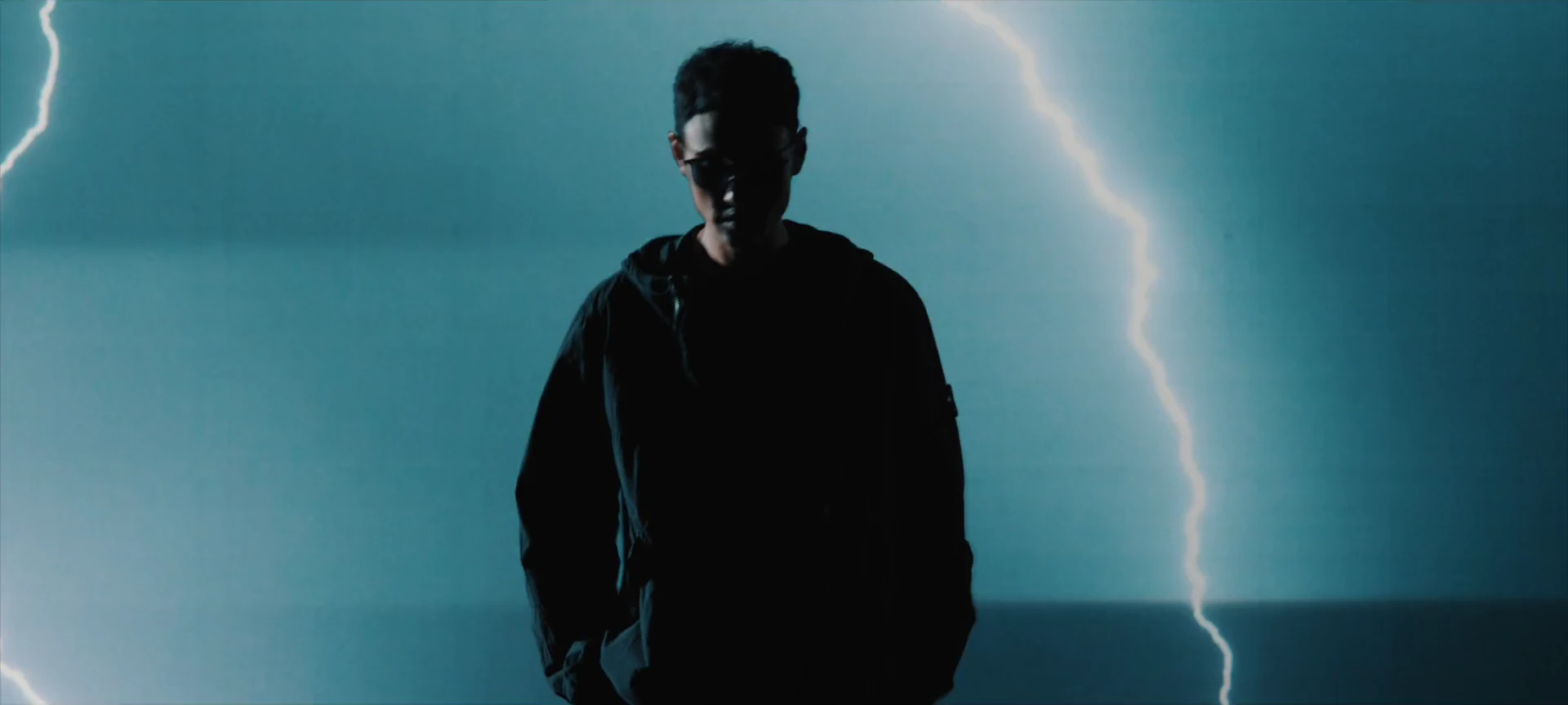 Ethan Juan moves through a cyan city and a lightning-lit world wearing KlassiC. sunglasses.