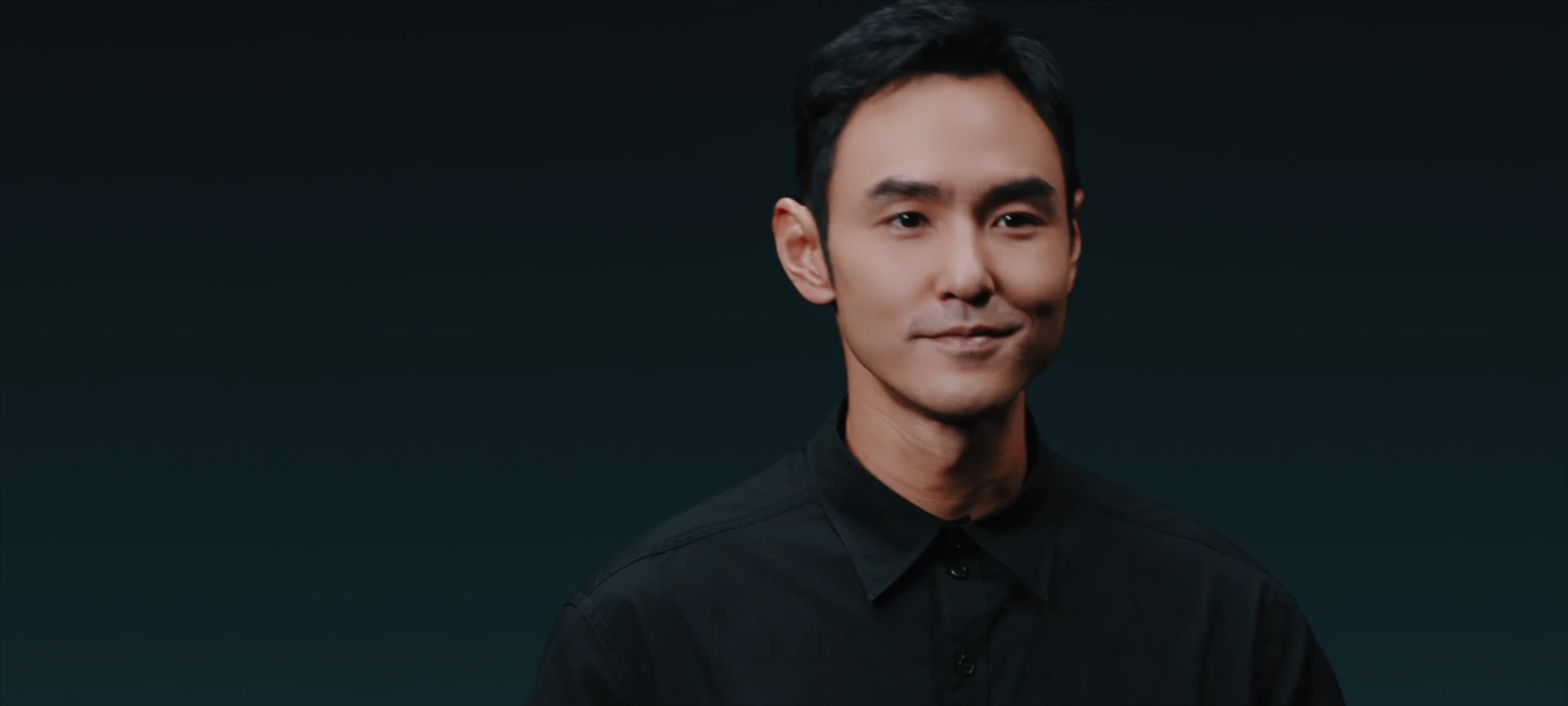 Ethan Juan in a composed studio portrait.