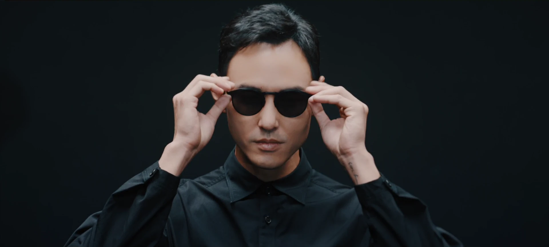 A frontal portrait of Ethan Juan wearing black KlassiC. sunglasses.
