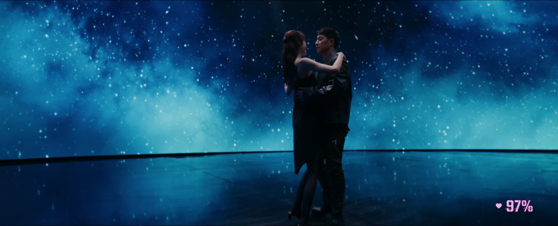 Will Pan and Charlize Lamb dance together in a wide view of the luminous galaxy world.