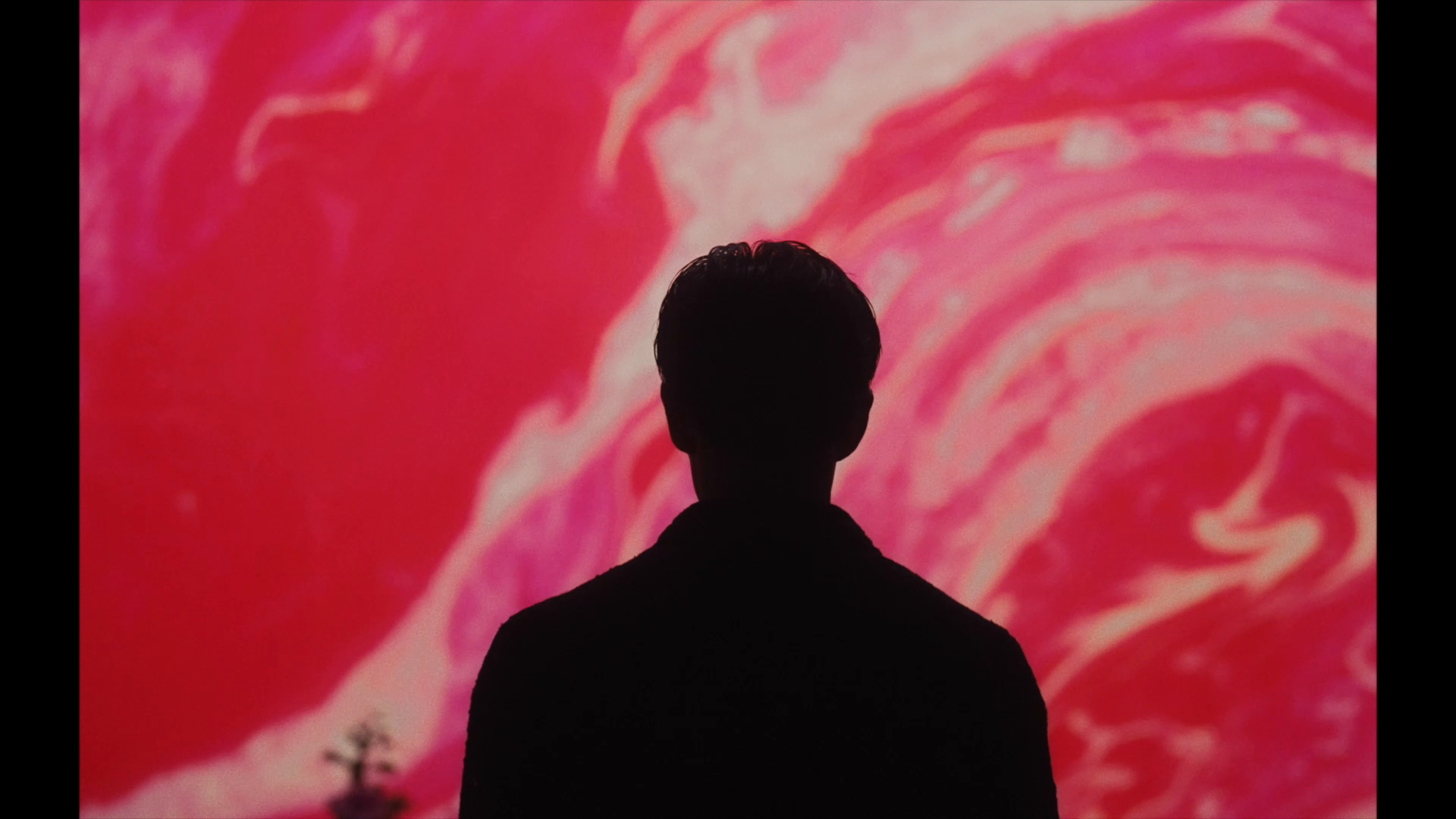 Silhouette against moving colour