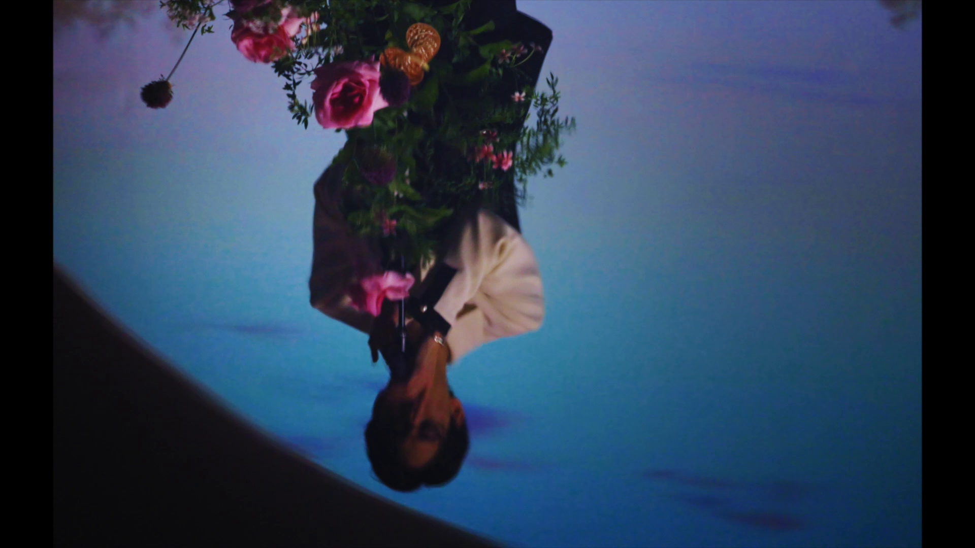 An inverted portrait with flowers
