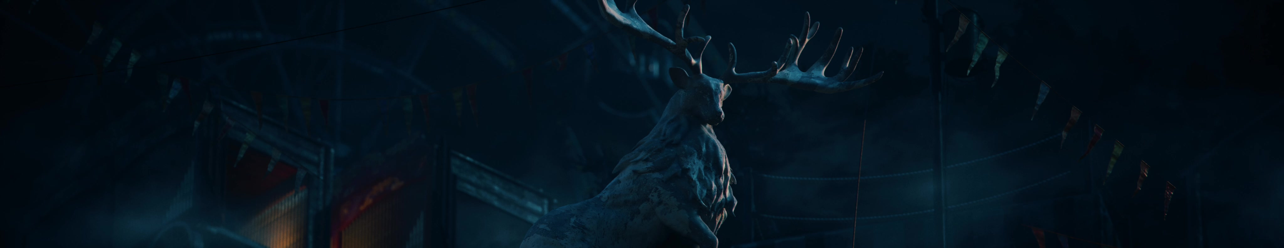An antlered stag figure rises inside a dark, weathered circus setting.