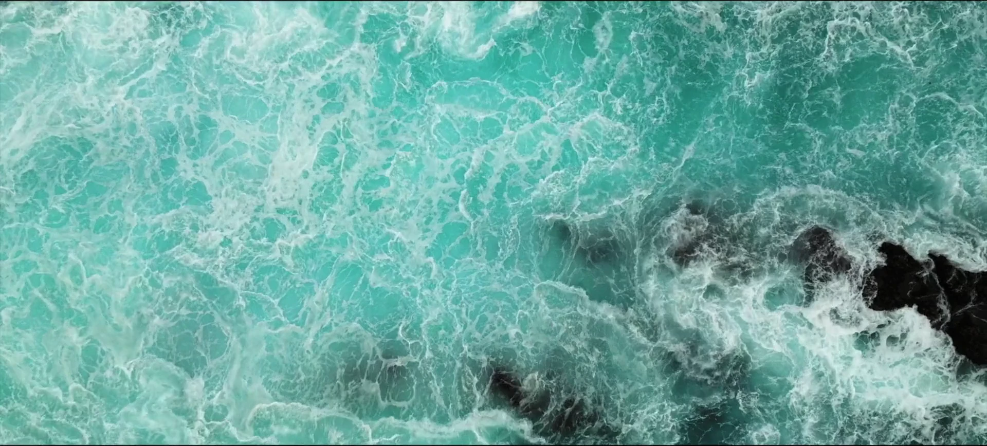 Meteor light, rock, storm clouds and turquoise surf lead into the PULSE world.