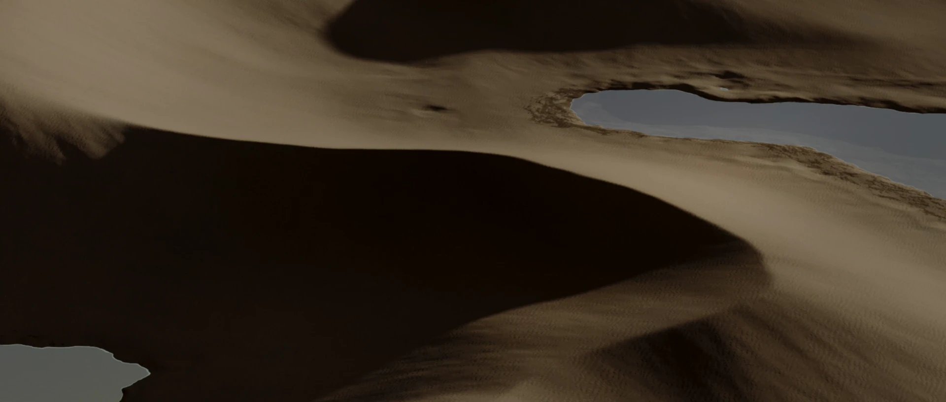 The camera moves across sculpted dunes and still pools of water.