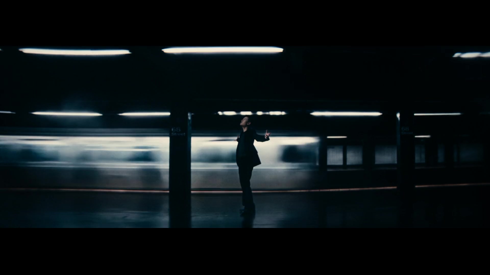 Eric Chou — Performer silhouetted beside a moving train