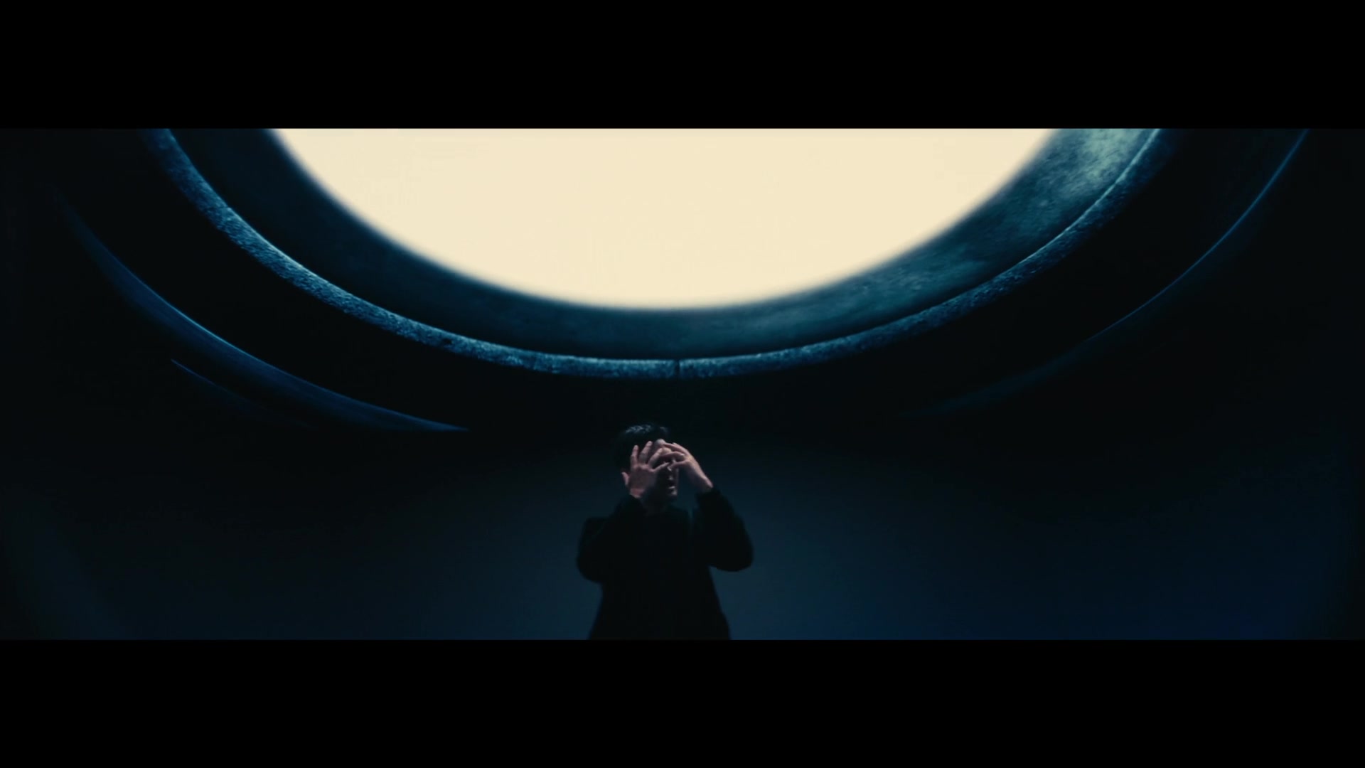 Eric Chou — Figure beneath a large circular light