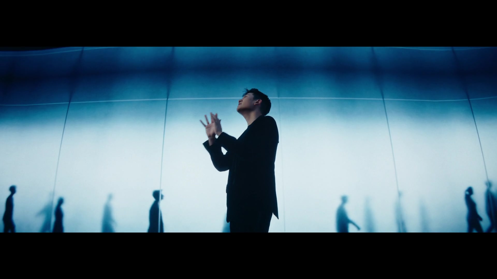 Eric Chou — Performer surrounded by blue silhouettes