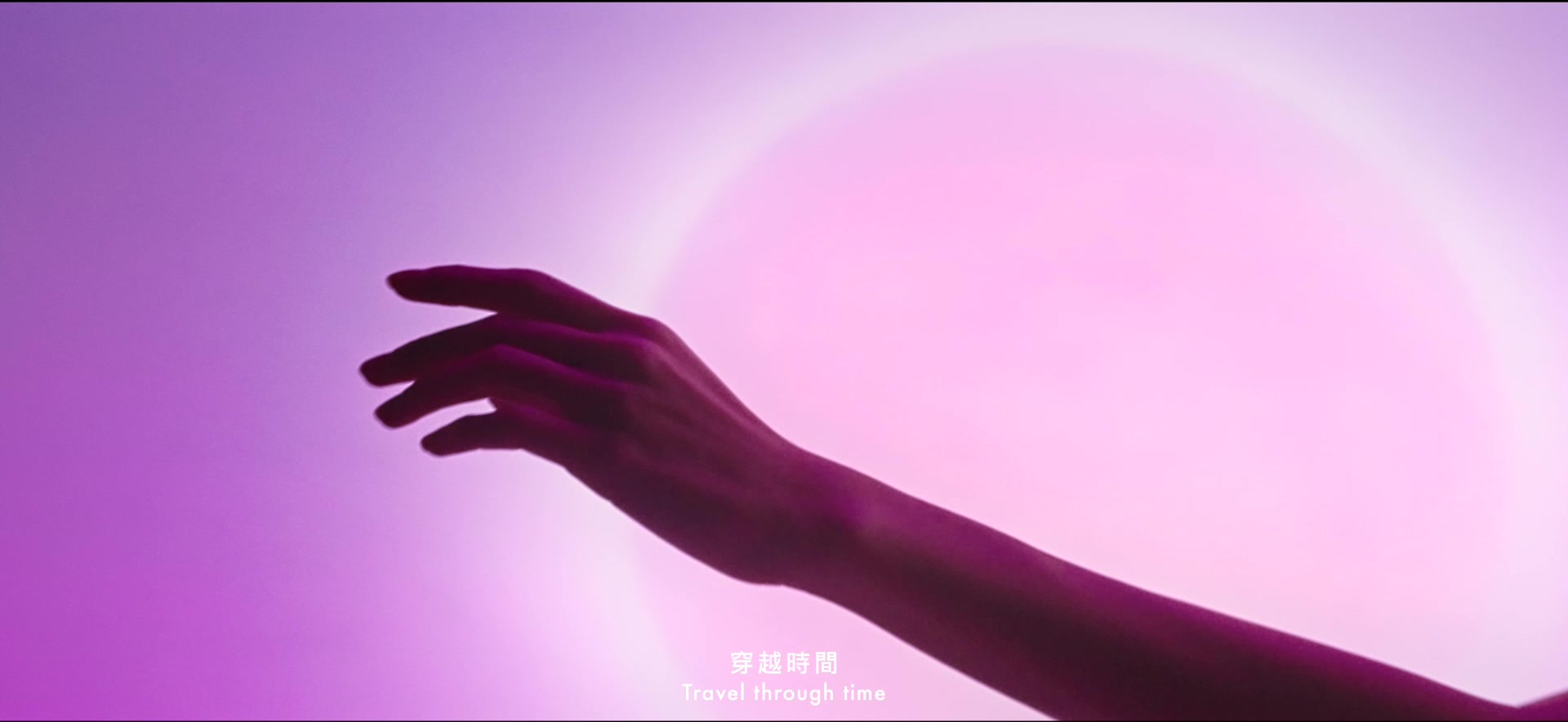Hand silhouetted against pink light