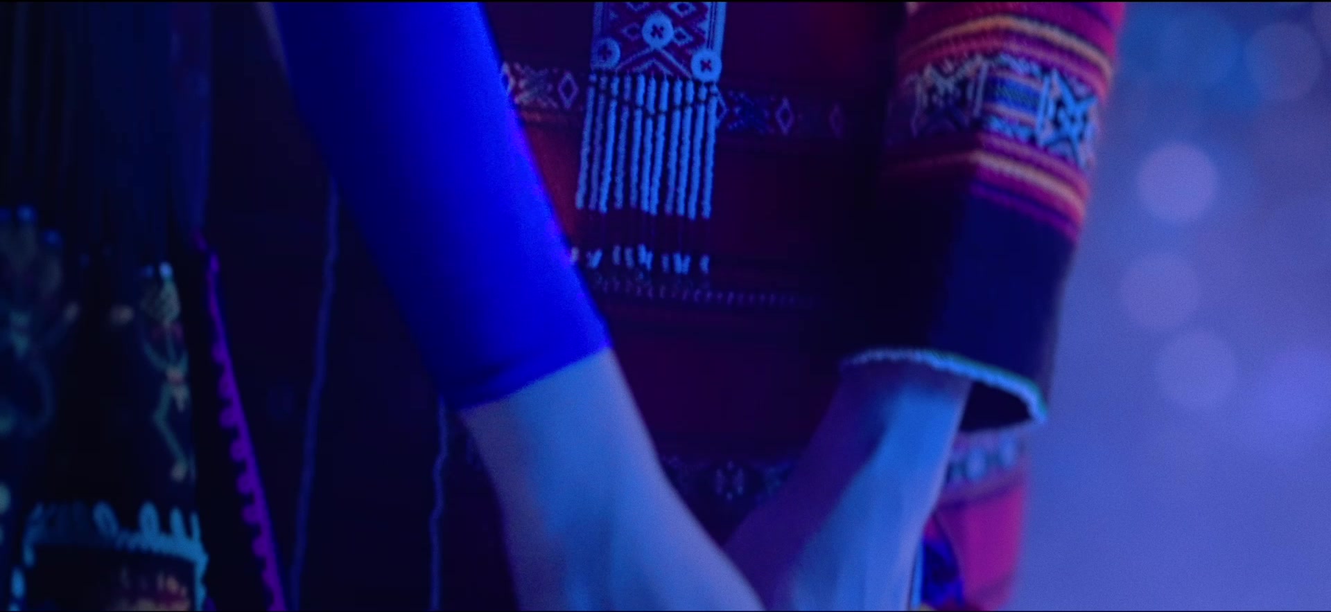 Costume and hand detail in blue light