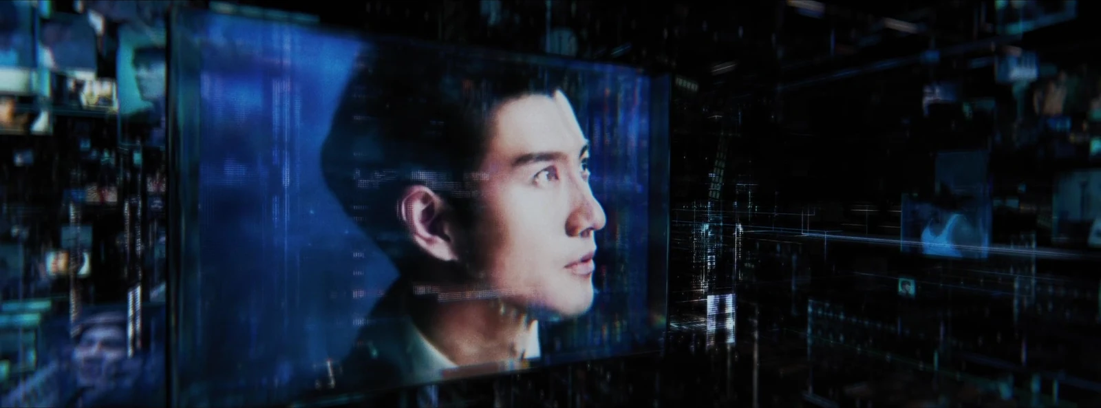 A large portrait appears amid illuminated screens and structures.