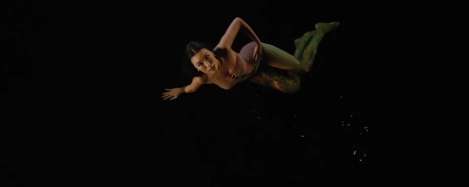 A floating figure against a black void.
