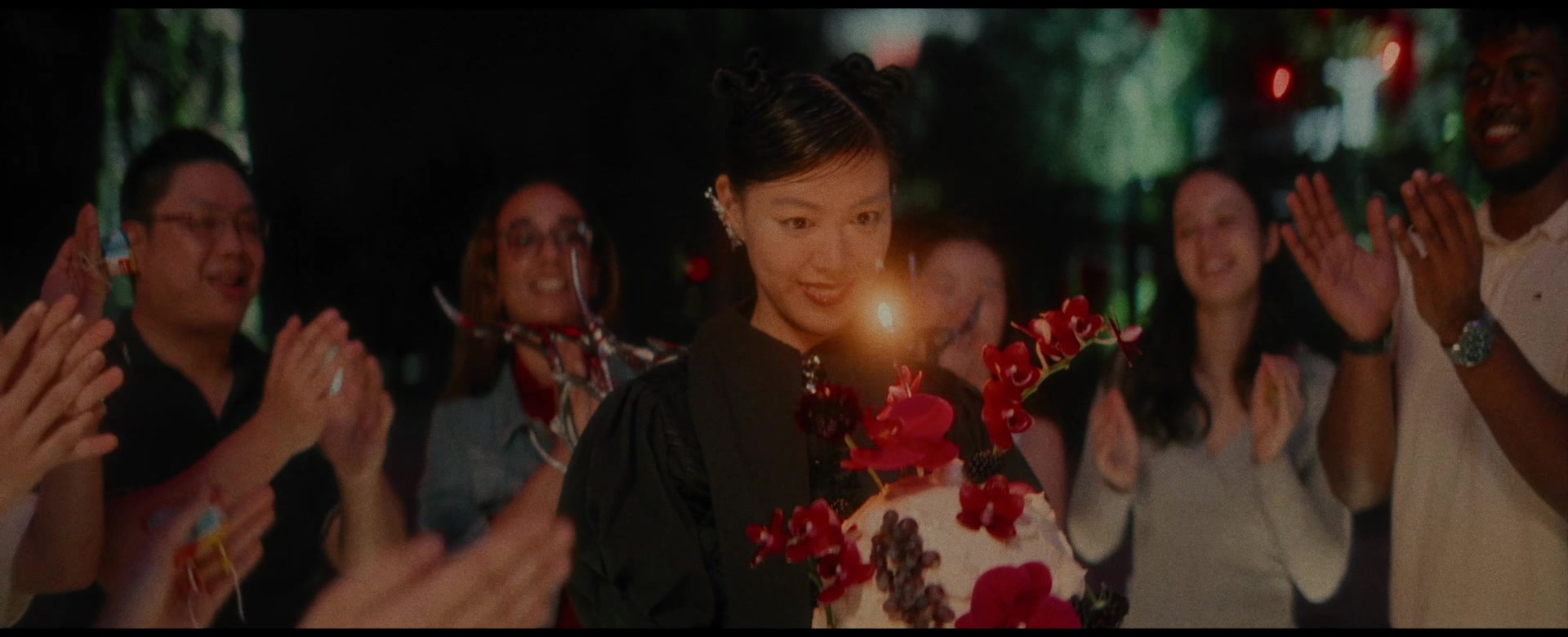 A child and friends celebrating with a birthday cake
